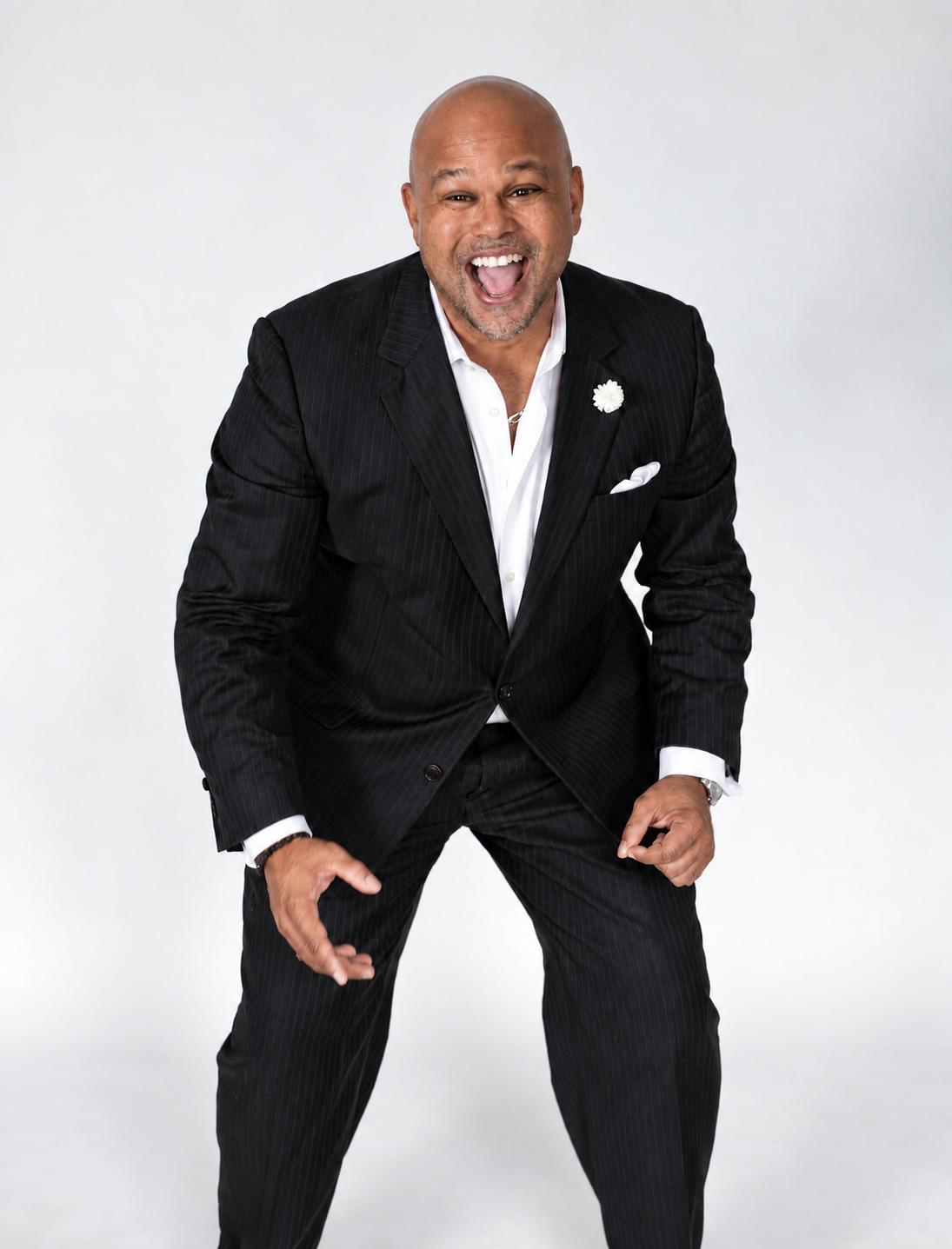 David Wilson laughing in a black suit and white shirt